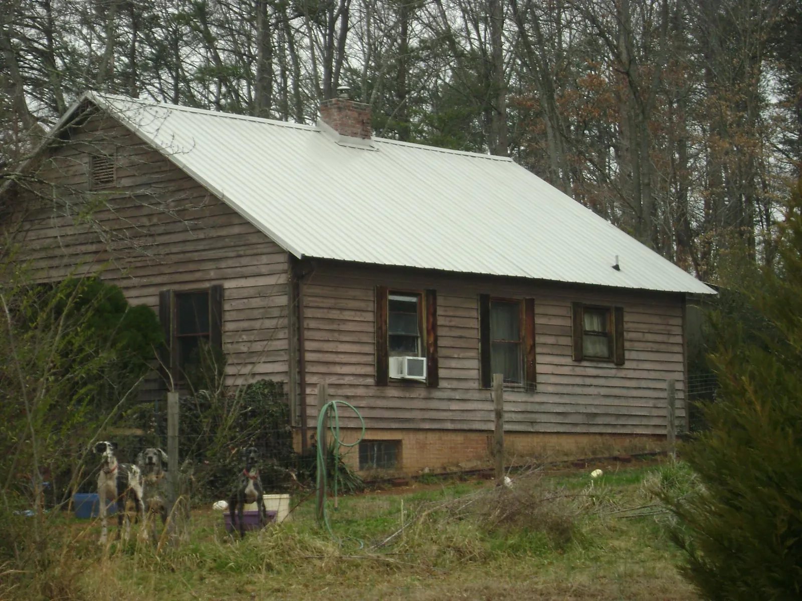 White metal roof on an old wood sided farmhouse, from a Metal Roof Installation job in White City
